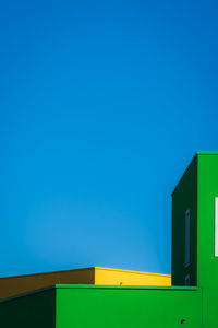 Low angle view of building against clear blue sky