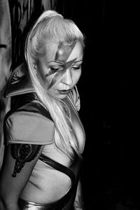 Young woman wearing hat at night