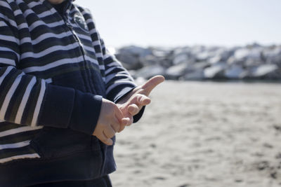 Midsection of boy at beach