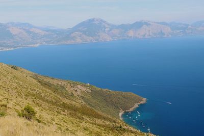 Scenic view of sea and mountains against sky