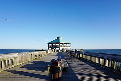 Long wooden jetty leading to sea