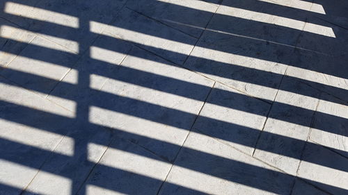 High angle view of shadow falling on road