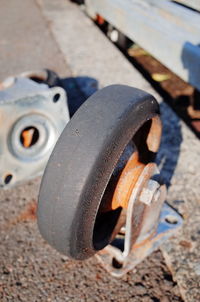 Close-up of rusty wheel on field