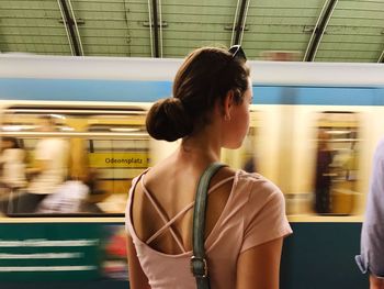 Rear view of woman on train at subway station