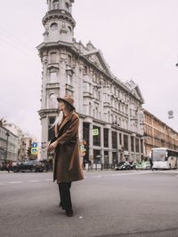 Woman with umbrella on street in city