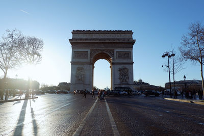 Triumphal arch against clear sky during sunny day