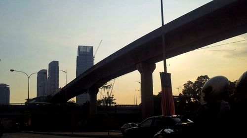 Modern cityscape against sky during sunset