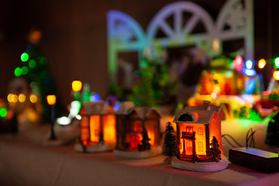 Close-up of illuminated cars on street against buildings at night