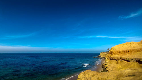 Scenic view of sea against blue sky