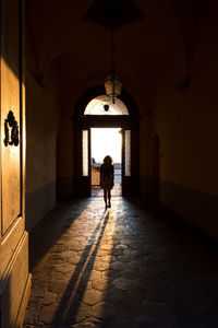 Rear view of woman walking in corridor