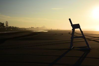 Scenic view of beach against sky during sunset