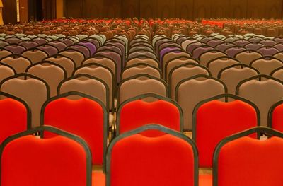 Empty chairs arranged at auditorium