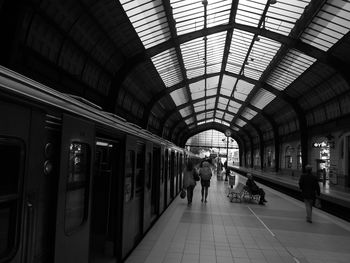 Group of people walking on railway station platform