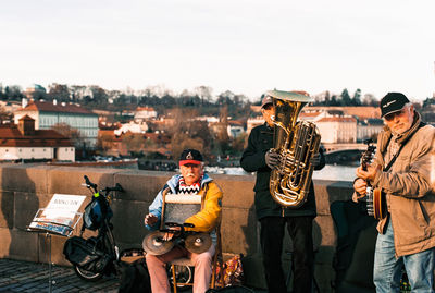Men on guitar against sky