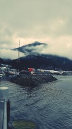 Scenic view of calm sea against mountain range