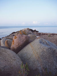 Rocks on beach against sky