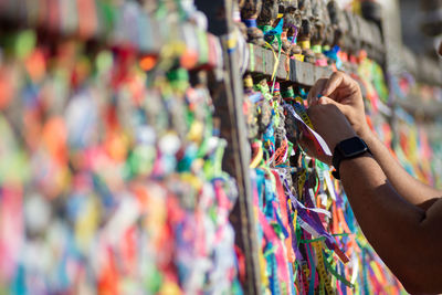 Cropped hand of woman holding padlocks