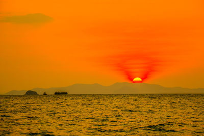 Scenic view of sea against orange sky