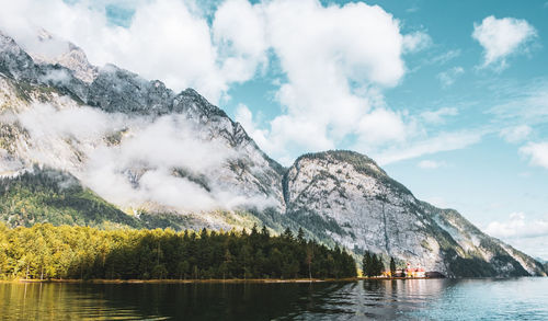 Scenic view of lake by trees against sky