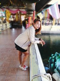 Portrait of smiling woman standing in water