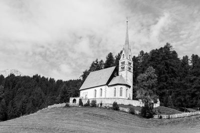 Panoramic view of buildings and trees against sky