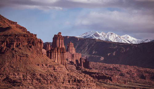 Panoramic view of rocks in mountains against cloudy sky