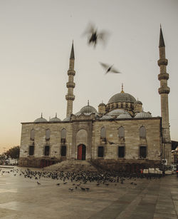 Mosque against clear sky at sunset