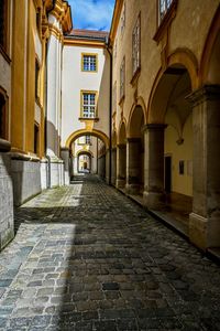 Empty alley amidst buildings in city