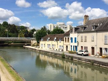 View of canal against cloudy sky