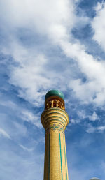 Low angle view of tower of building against cloudy sky