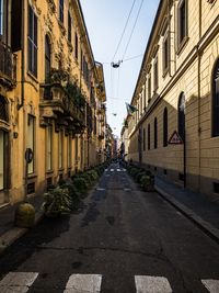 Narrow street amidst buildings in city