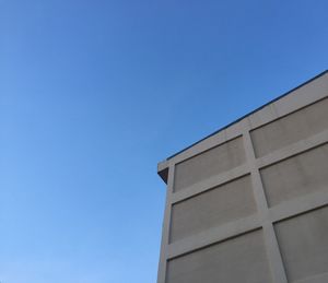 Low angle view of building against clear blue sky
