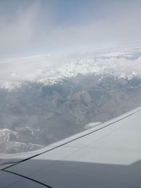 Aerial view of snowcapped mountains against sky