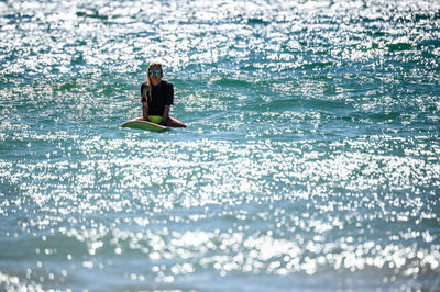 Woman surfing in sea