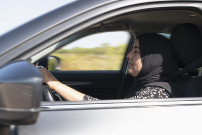 Young woman sitting in car