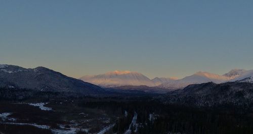 Scenic view of snowcapped mountains against clear sky