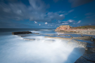 Scenic view of sea against cloudy sky