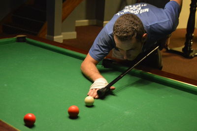 Young man playing snooker