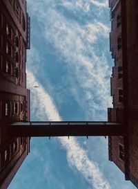Low angle view of bridge and buildings against sky