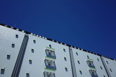 Low angle view of building against clear blue sky