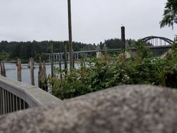 Surface level of bridge over river against sky