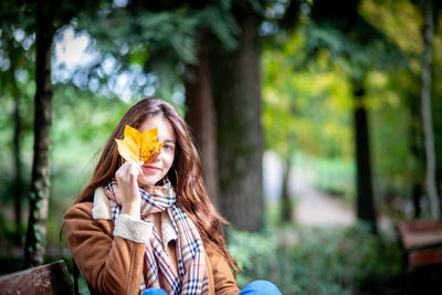 Portrait of young woman with umbrella