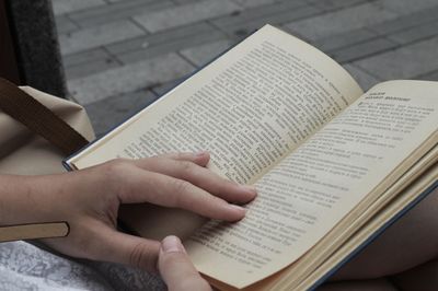 Cropped image of hand holding book