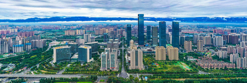 Aerial view of modern buildings in city against sky