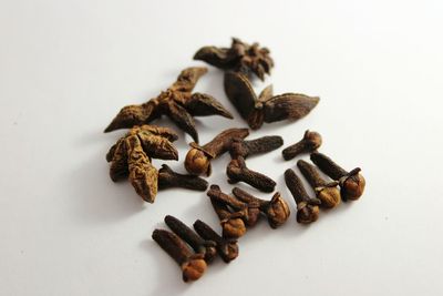 Close-up of roasted coffee beans against white background