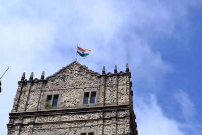 Low angle view of building against cloudy sky
