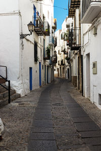 Empty alley amidst buildings in town