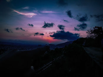 Scenic view of silhouette land against sky at sunset