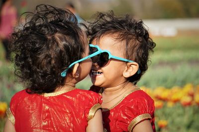 Portrait of happy sisters during sunny day