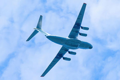 Low angle view of airplane flying against sky